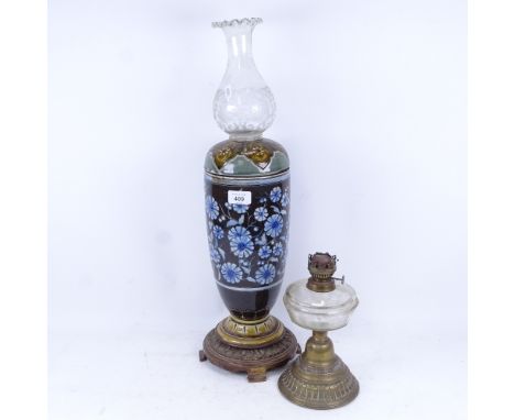 A Doulton Lambeth stoneware oil lamp, and a smaller brass oil lamp, largest height excluding shade 42cm (2) 