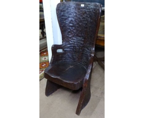 An unusual solid tree trunk dugout chair or Kubbestol, with adzed finish and sculpted seat