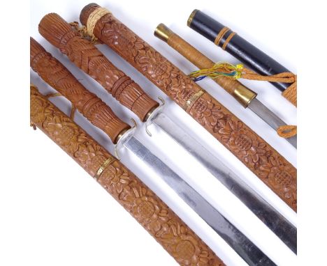 A pair of Oriental swords in carved wood scabbards, with carved handles, length 91cm, and an Oriental sword in cane-bound lac