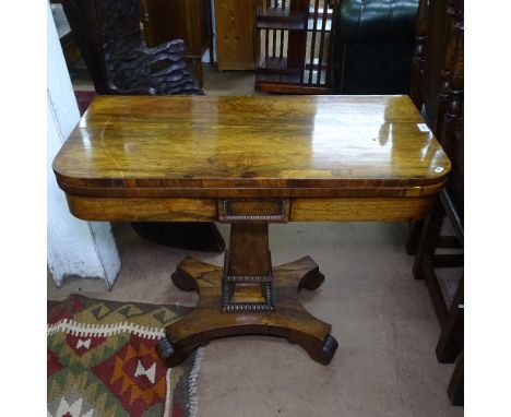 A Regency rosewood fold over card table, on a tapered centre column and platform base, W89cm, H71cm, D43cm 