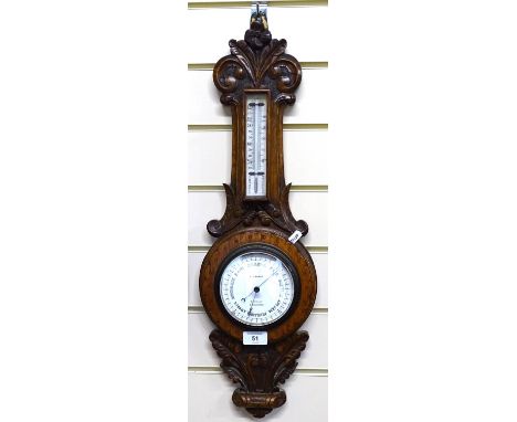 An oak-cased aneroid barometer and thermometer, with floral carved cased, height 62cm 