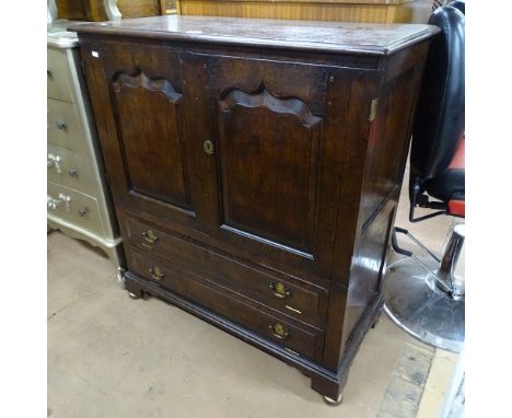 A Georgian style oak cabinet, with 2 fielded panelled doors, and fall-front under, on bracket feet, W95cm, H104cm, D45cm 