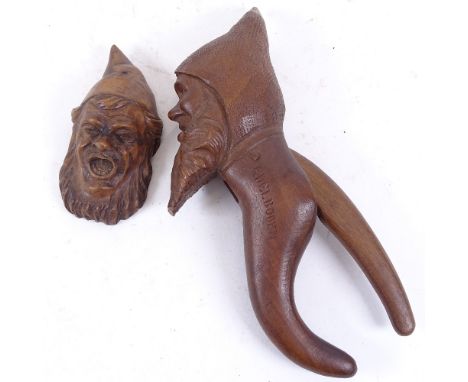 A 19th century carved wood Black Forest figural nutcracker, engraved Adel Boden, and a similar carved wood gnome-head ornamen