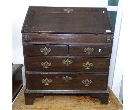 An early 18th century oak bureau, with a fitted and well interior, 2 short and 2 long drawers under, bracket feet, W80cm, H93