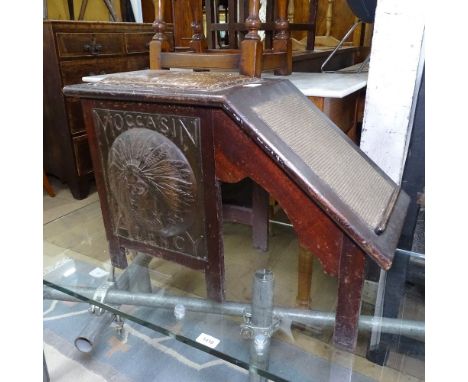 An American Arts and Crafts Moccasin Agency shoe fitting stool in oak, the sides with two repousse coppered metal Indian head