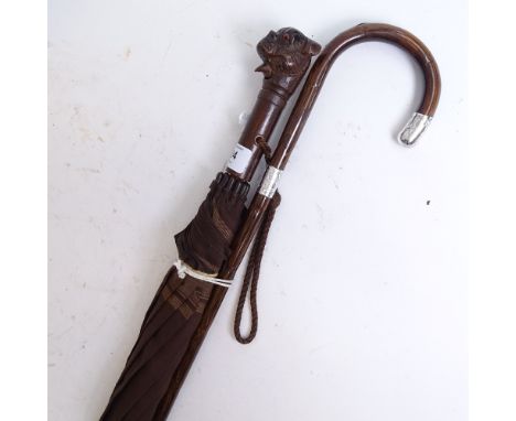 An early 20th century silver-mounted bamboo walking stick, and a novelty carved wood dog's-head umbrella, with moving mouth, 