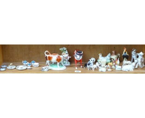 Various ceramic animal figures, including cow creamer, cow parade beefeater etc 