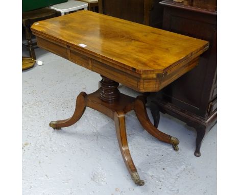 A Regency mahogany and ebony-strung fold over card table, on a turned centre column, and raised sabre leg base, W91cm 