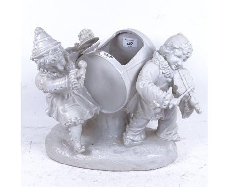 A Continental white glaze porcelain table centre jardiniere, in the form of 2 children playing musical instruments, height 28