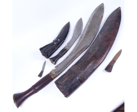 A large Gurkha kukri knife, probably mid-20th century, in leather scabbard, together with a smaller kukri knife (2), larger k