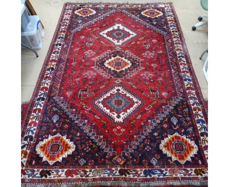 A red ground Afghan design carpet, with geometric pattern, 220cm x 115cm 