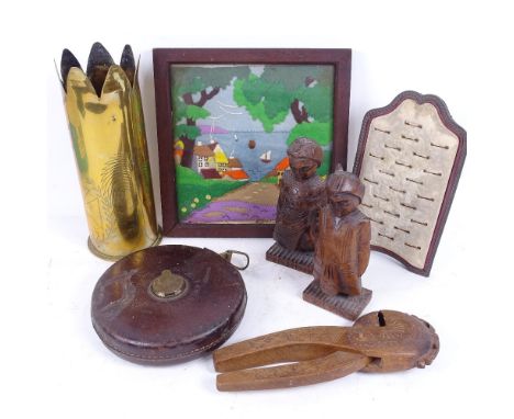 A mixed group of items, including a ring display easel, Scandinavian carved wood nutcrackers, pair of carved wood figures, a 