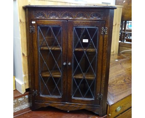 A small oak corner cabinet with lead-light glazed doors, W70cm, H86cm 
