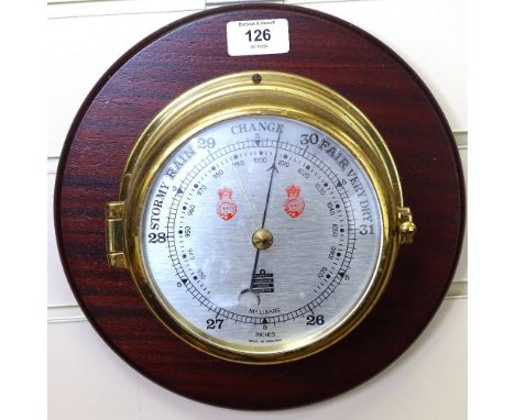 A Sewills brass barometer on oak plaque, diameter 28cm 