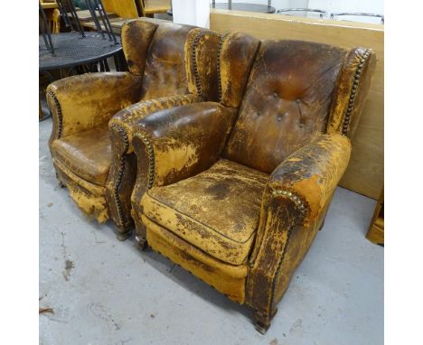 A pair of Vintage brown leather and button-back upholstered wing armchairs 