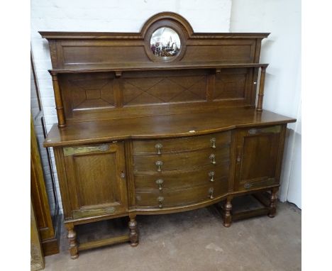 An early 20th century oak sideboard, with raised shelf and panelled mirror-back, 4 bow-fronted drawers flanked by panelled cu