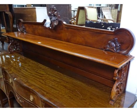 A mahogany shelf, with raised shaped top, and carved and pierced sides, L168cm, H66cm, D26cm 