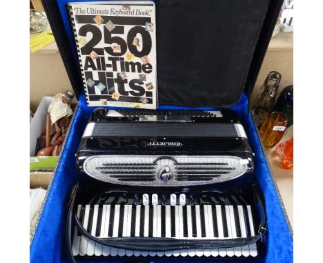 A Giulietti piano accordion in fitted box, together with various sheet music 