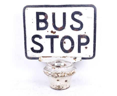 A Vintage relief cast-iron bus stop sign, on iron base, overall height 35cm 