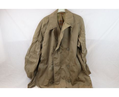 A Small Collection Of Military Clothing To Include A Demobilised Soldiers Raincoat Dated 1956 And Marked With The Broad Arrow