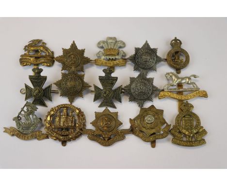 A Collection of 15 British Military Cap Badges To Include The West Riding Regiment, The East Yorkshire Regiment, The Royal Ar