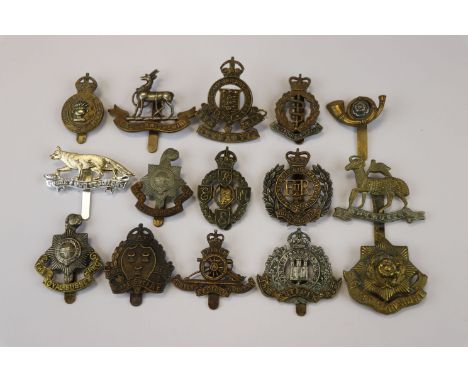 A Collection Of 15 British Military Cap Badges To Include The Army Catering Corps, The Royal Warwickshire Regiment, The Suffo