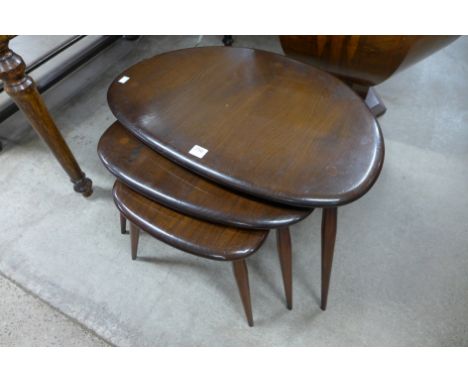 An Ercol pebble shaped nest of three tables