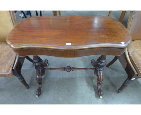 A Victorian mahogany serpentine card table