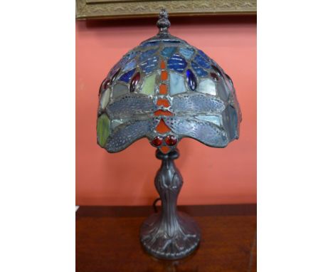 A small Tiffany style table lamp