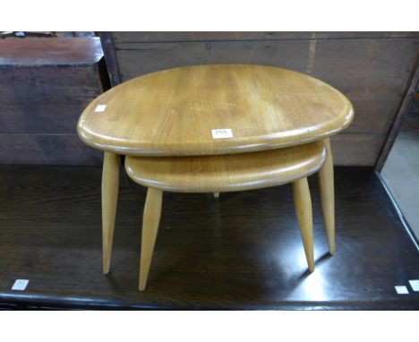 An Ercol pebble shaped nest of two tables