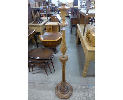 A carved walnut standard lamp