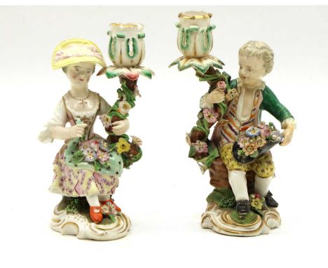 A pair of Meissen style candlesticks, late 19th century, each modelled as a young boy and girl,14cm highCondition report: Loo