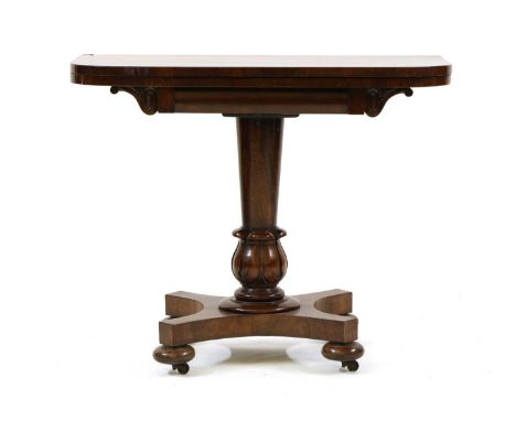 A William IV rosewood card table,early 19th century, the fold over rectangular top on turned and carved pedestal and quatrefo