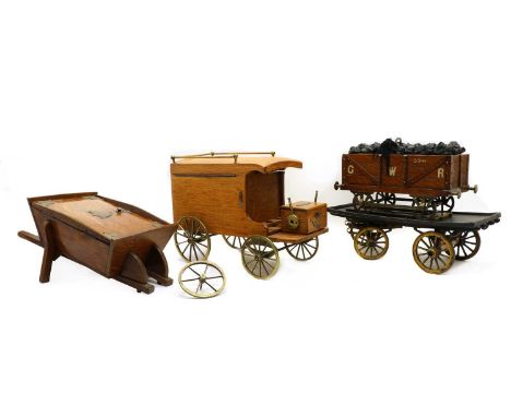 A collection of three novelty boxes,20th century, modelled as a wheelbarrow, 39cm long, a Fender truck, 28cm long and a carav