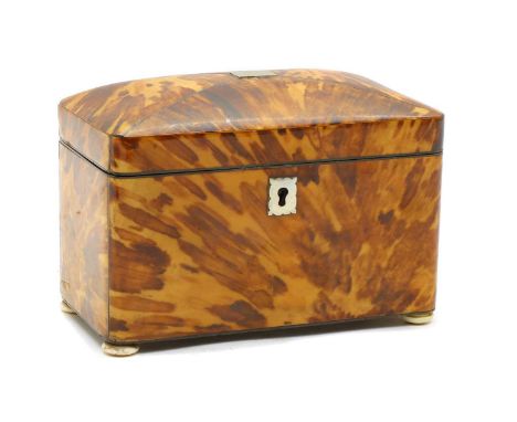 A blonde tortoiseshell twin compartment tea caddy,19th century, with metal stringing, a white metal plaque to the cover and a