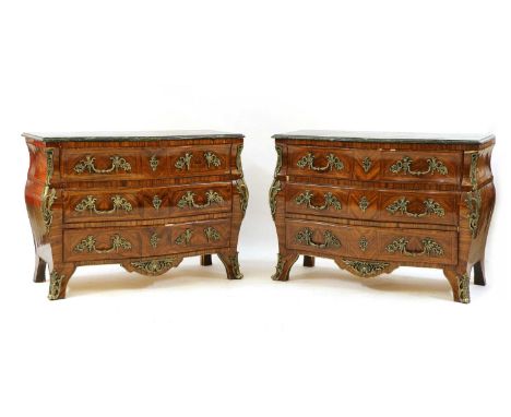 A pair of Louis XVI style kingwood commode chests, 20th century, the green marble serpentine tops above three drawers on cabr