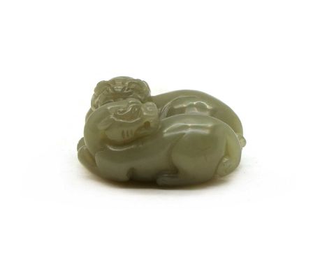 A Chinese jade carving, of a recumbent Buddhist lion with a pup to its side, 5.5cm longCondition report: No obvious faults.