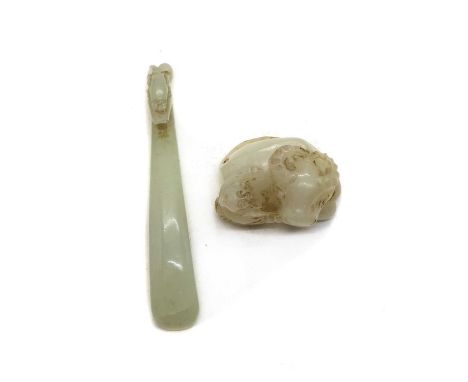 Two Chinese jade carvings,19th-20th century, comprising: one of a belt hook, of typical form, carved with a dragon's head to 