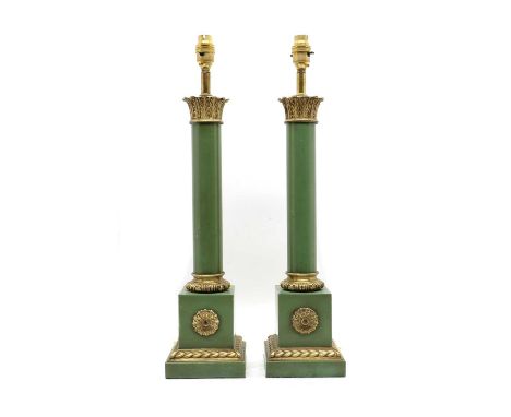 A pair of green and gilt metal lamps, of recent manufacture, the Egyptian capital above the column, on square section stepped