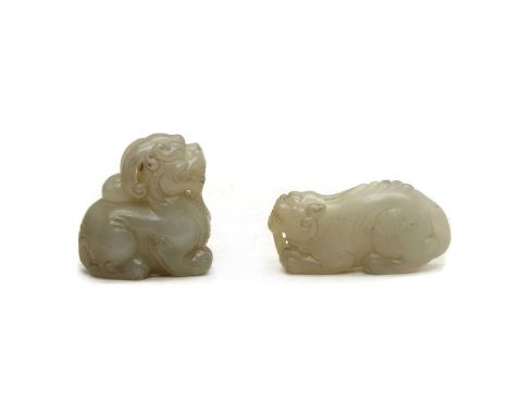Two Chinese jade carvings,20th century, comprising: a mythical beast, seated on his haunches, 6.5cm high, and another, recumb