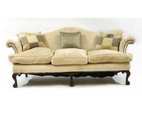 A camel back sofa,of recent manufacture, the shaped backrest, above a three-cushion sprung seat, raised on cabriole legs term