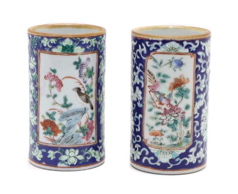 A pair of Chinese famille rose brush pots, 19th century, of cylindrical form, painted with birds and flowers in shaped panels