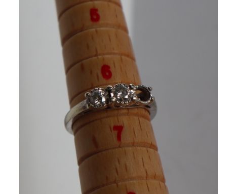 A two stone diamond ring, the round old cut diamonds in rub over settings to a 9ct white gold setting and shank, overall appr