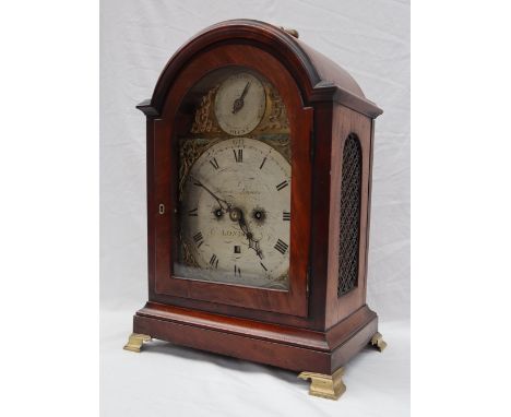 A George III mahogany Bracket Clock, with a brass carrying handle to the domed top, with a glazed door on brass bracket feet,