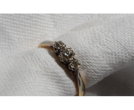 A three stone diamond ring, set with graduated round old cut diamonds to a white metal setting and shank, marked 18ct &amp; P