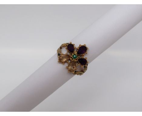 A suffragette type ring, set with citrines, amethysts and an emerald, to a yellow metal setting and shank, size K, approximat