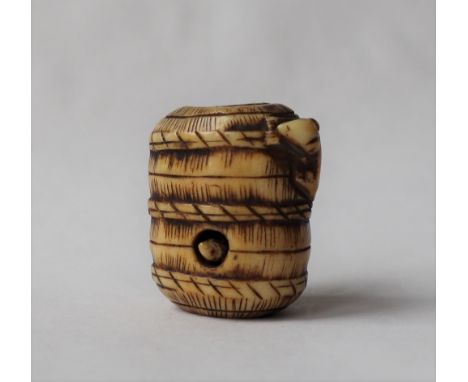 A 19th century Japanese ivory netsuke in the form of a basket, with a rat peeping out and another on the exterior, 28mm high 