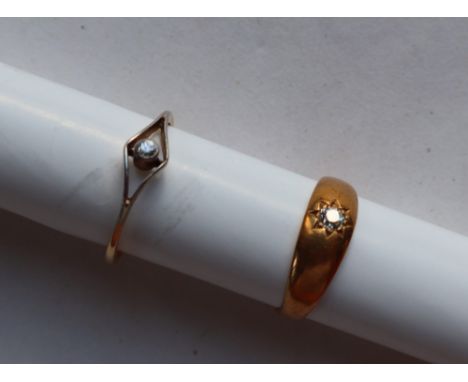 A yellow metal ring, set with an old round cut diamond, marked 15ct, size K, approximately 4 grams together with a diamond so
