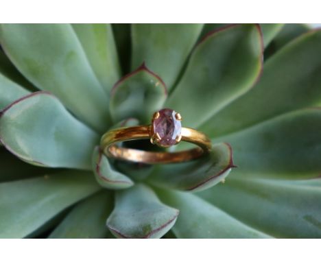 A ruby ring, the oval faceted ruby to a 22ct yellow gold setting and shank, size R, approximately 5.8 grams CONDITION REPORT: