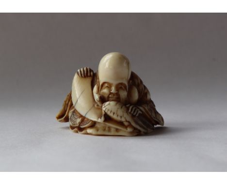 A 19th century Japanese ivory netsuke, depicting Fukurokuju with a turtle, 30mm high